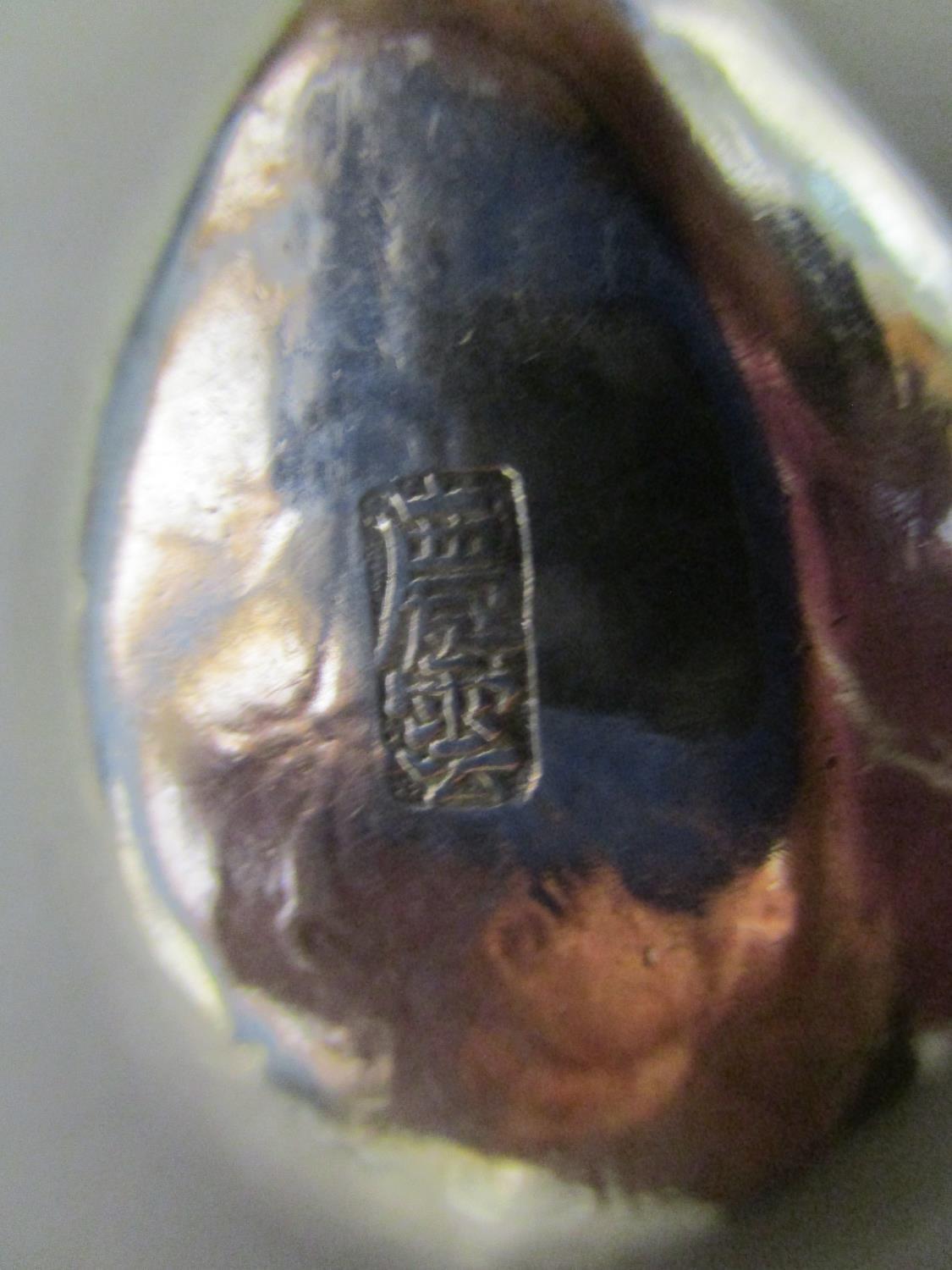 A Chinese silver rice spoon with floral engraved decoration and stylized finial, signed verso, - Image 2 of 2