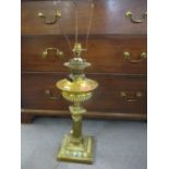 An early 20th century brass column table lamp converted from an oil lamp