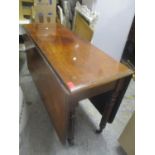 A Victorian mahogany fall flap table standing on turned and fluted legs, 69" h x 106"w