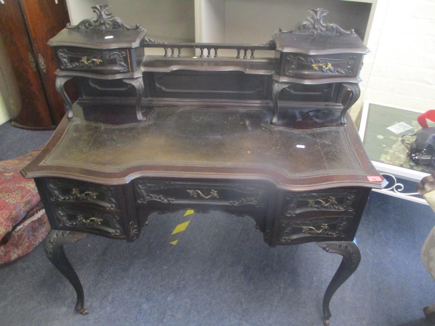 A late 19th century mahogany writing table having a leather topped scriber with a raised back and