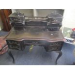 A late 19th century mahogany writing table having a leather topped scriber with a raised back and