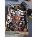 A quantity of mixed vintage cameras and lenses to include Praktica, Minolta, Yashica, Mimy and