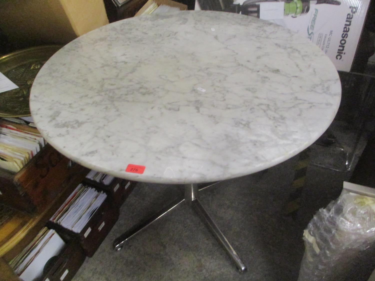 A modern circular marble topped occasional table on chrome supports, 74"h x 90"w