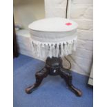 A Victorian carved walnut piano stool with a rotating upholstered seat