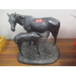A cast bronze model horse and foal