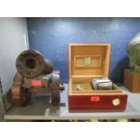 A Humidor with various smoking accessories and a wooden model of a canon