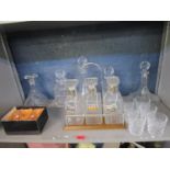 A mixed lot of table glass to include a three bottle decanter set with solver plated labels,