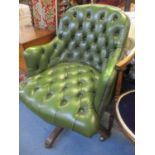 A modern green leather button back upholstered swivel office chair