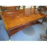 A large reproduction mahogany two tier coffee table having two inset drawers and fluted tapering