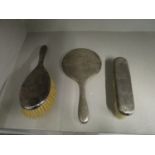 A silver clad three piece dressing table brush and mirror set, Birmingham hallmarks