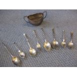 A quantity of silver items to include a twin handled sugar bowl and mixed spoons and a fork, total