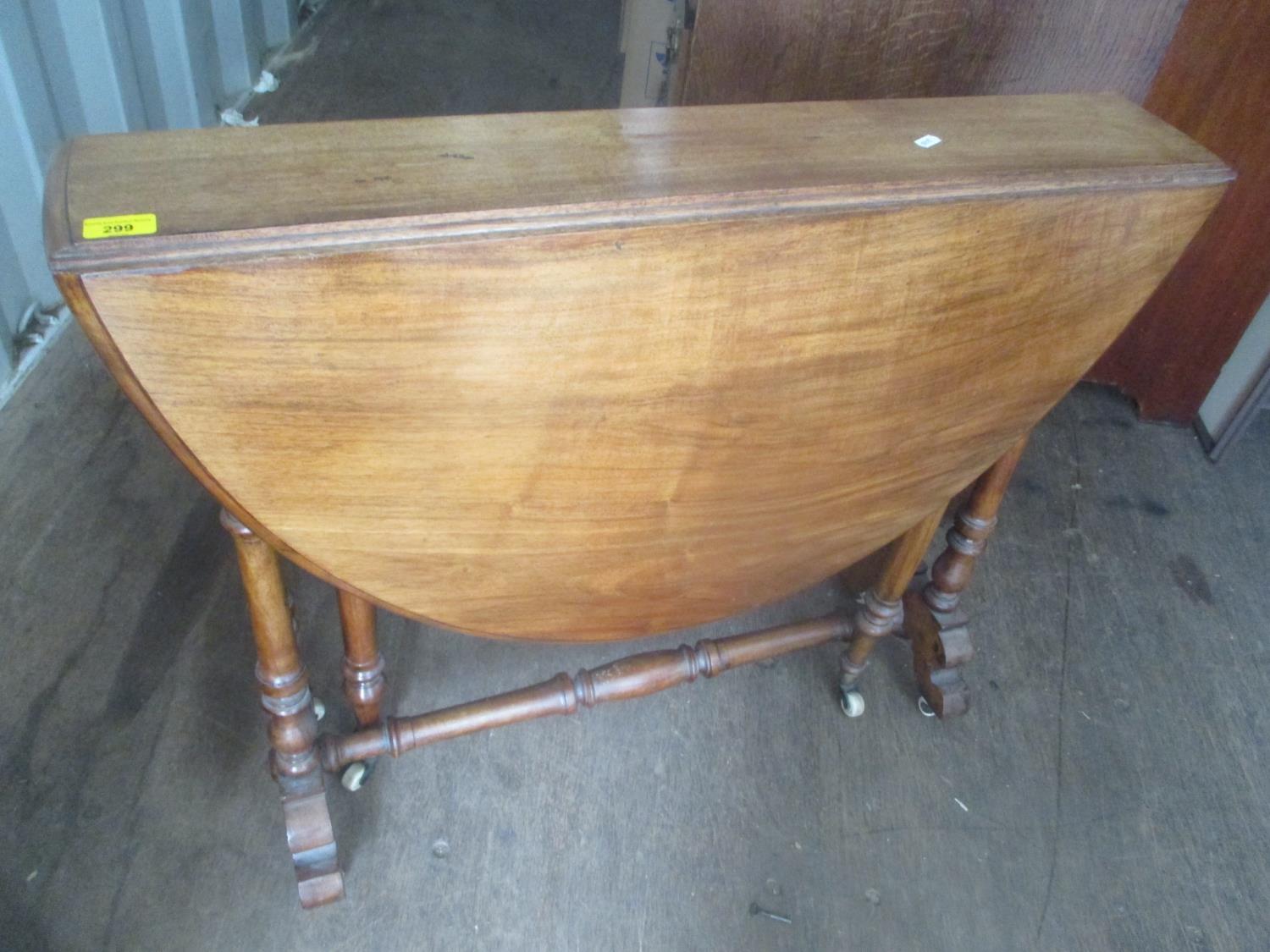 A Victorian walnut Sutherland table having turned columns and standing on castors, 71" h x 88"w