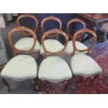 A set of six Victorian walnut balloon back dining chairs