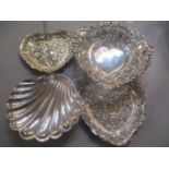 Four silver trinket dishes to include a pair of Victorian embossed, heart shaped dishes