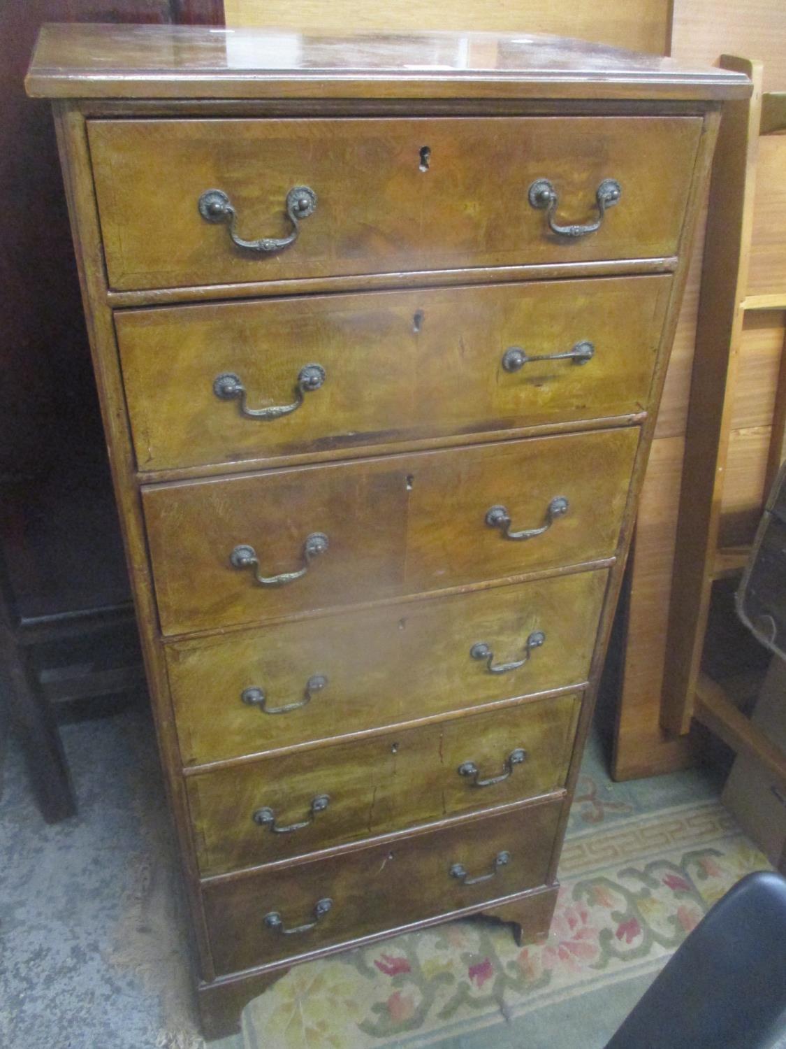 An early 20th century walnut tallboy chest of six drawers standing on bracket shaped feet 135.5cm