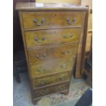 An early 20th century walnut tallboy chest of six drawers standing on bracket shaped feet 135.5cm