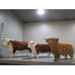 A Beswick highland bull and two Beswick Hereford bulls, one marked CH of Champions