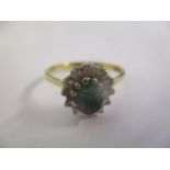 An 18ct gold ring set with an emerald and diamonds 3.3g
