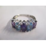 A 9ct white gold ring set with blue and purple stones 2.95g