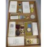 A collection of silver gilt Masonic medals and others housed within a wooden cigar box