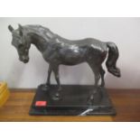 A cast bronze model horse on a marble plinth