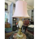 A white onyx and brass table lamp of vase design with a shade