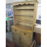 A Victorian pine dresser having shelves above two drawers and two cupboard doors, 189h x 108w