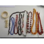 Jewellery to include amber coloured necklaces, a bakalite necklace70 g, bone jewellery and beaded