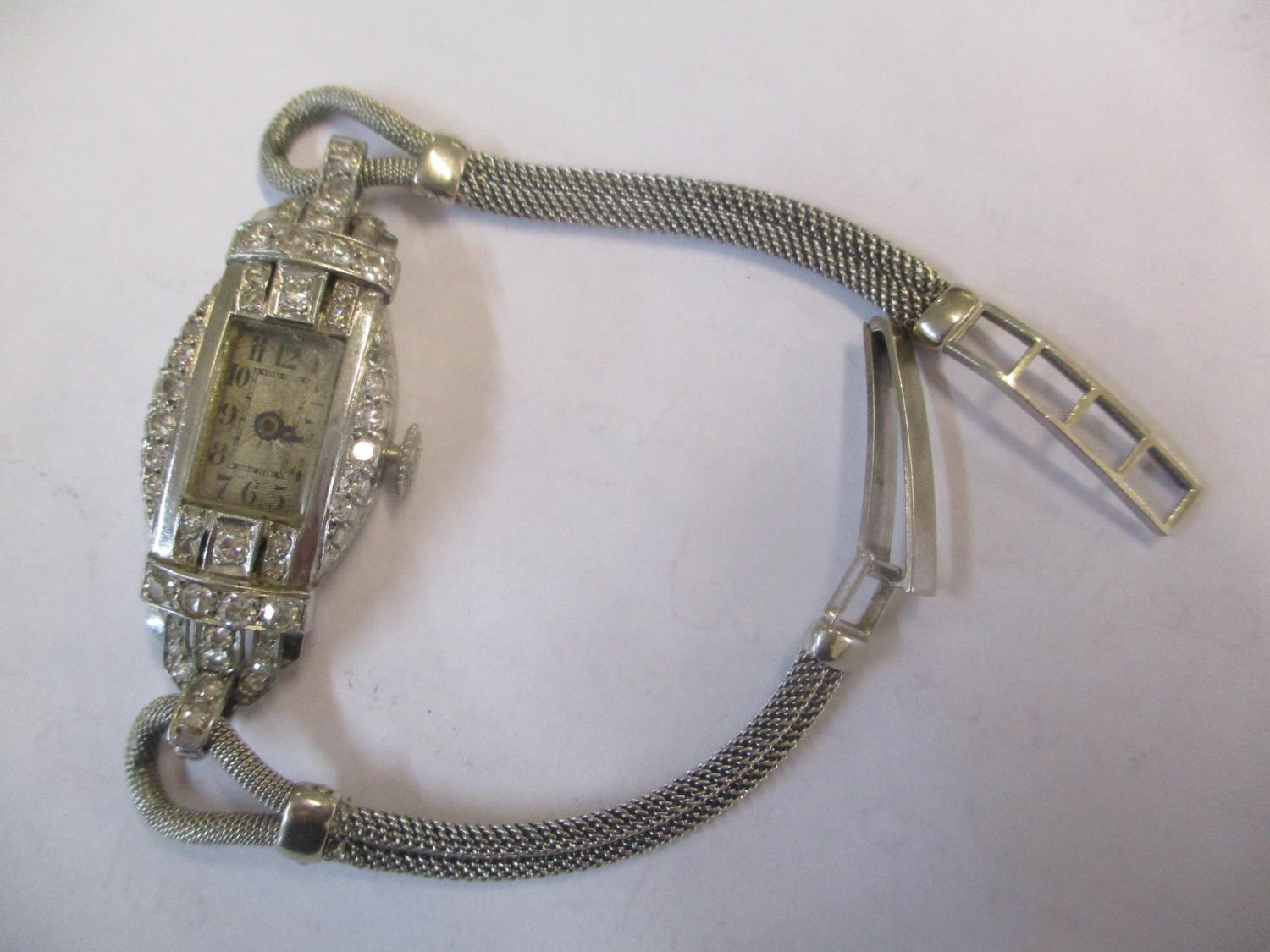 An Art Deco white metal diamond inset cocktail watch