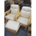 A pair of conservatory wicker armchairs and a foot stool together with a modern cream upholstered