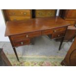 A late Victorian satinwood inlaid mahogany writing desk with four drawers on square tapered legs and