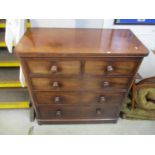 A Victorian mahogany chest of five drawers on bun feet