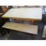A pine plank constructed table and an oak bench