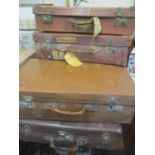 A selection of six vintage leather suitcases