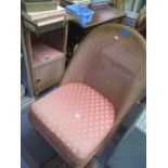 A pink finished Lloyd Loom chair with upholstered seat and a matching pot cupboard, an upholstered