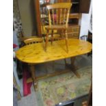 A modern pine extending dining table and a matching set of six chairs