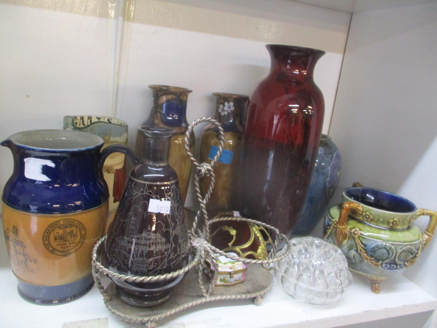 Royal Doulton stoneware to include a pair of vases, a three handled vase and a series ware jug