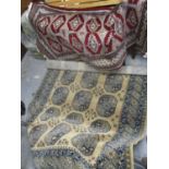 A machine made rug and a Bokhara rug