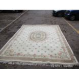 A large Indian carpet with regency style designs on a cream ground 397cm x 308cm