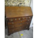 A George III mahogany five drawer bureau, on bracket feet 109h x 98cmw