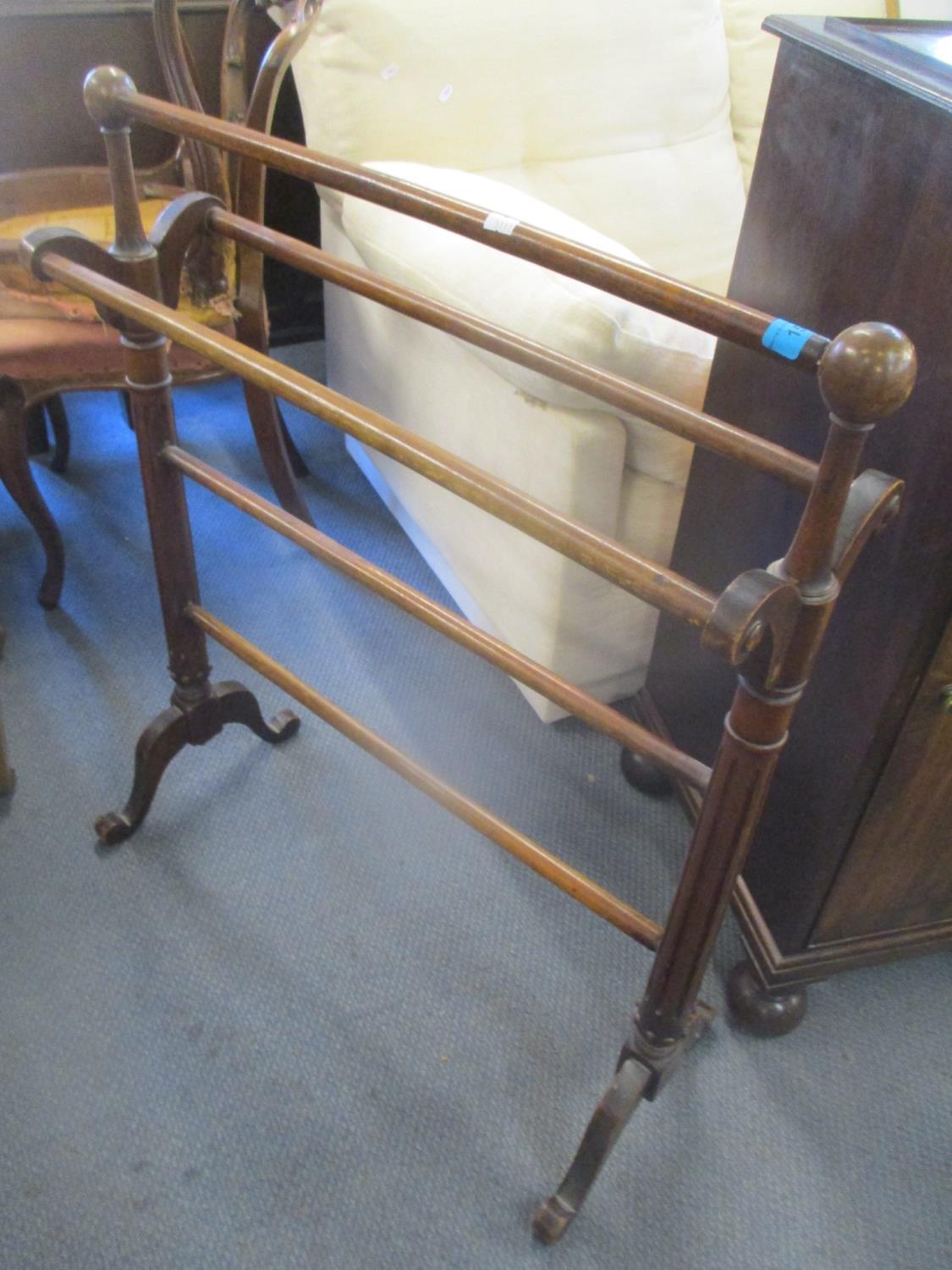 A Victorian walnut towel rail having fluted supports, 84h x 69w