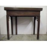 A George III Chippendale style mahogany tea/card table with a double foldover top, on square moulded