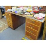 A partners pedestal desk with four drawers each side, in oak with a green leather scriber, mid