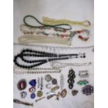 A quantity of 20th century costume jewellery to include Scottish silver backed and hardstone