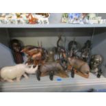 A collection of African carved wooden and soapstone figures and animals
