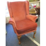 A pink Dralon upholstered armchair on beech cabriole legs