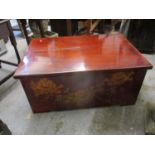 A Chinese polish and painted elm chest with a part detachable top, decorated with flowers