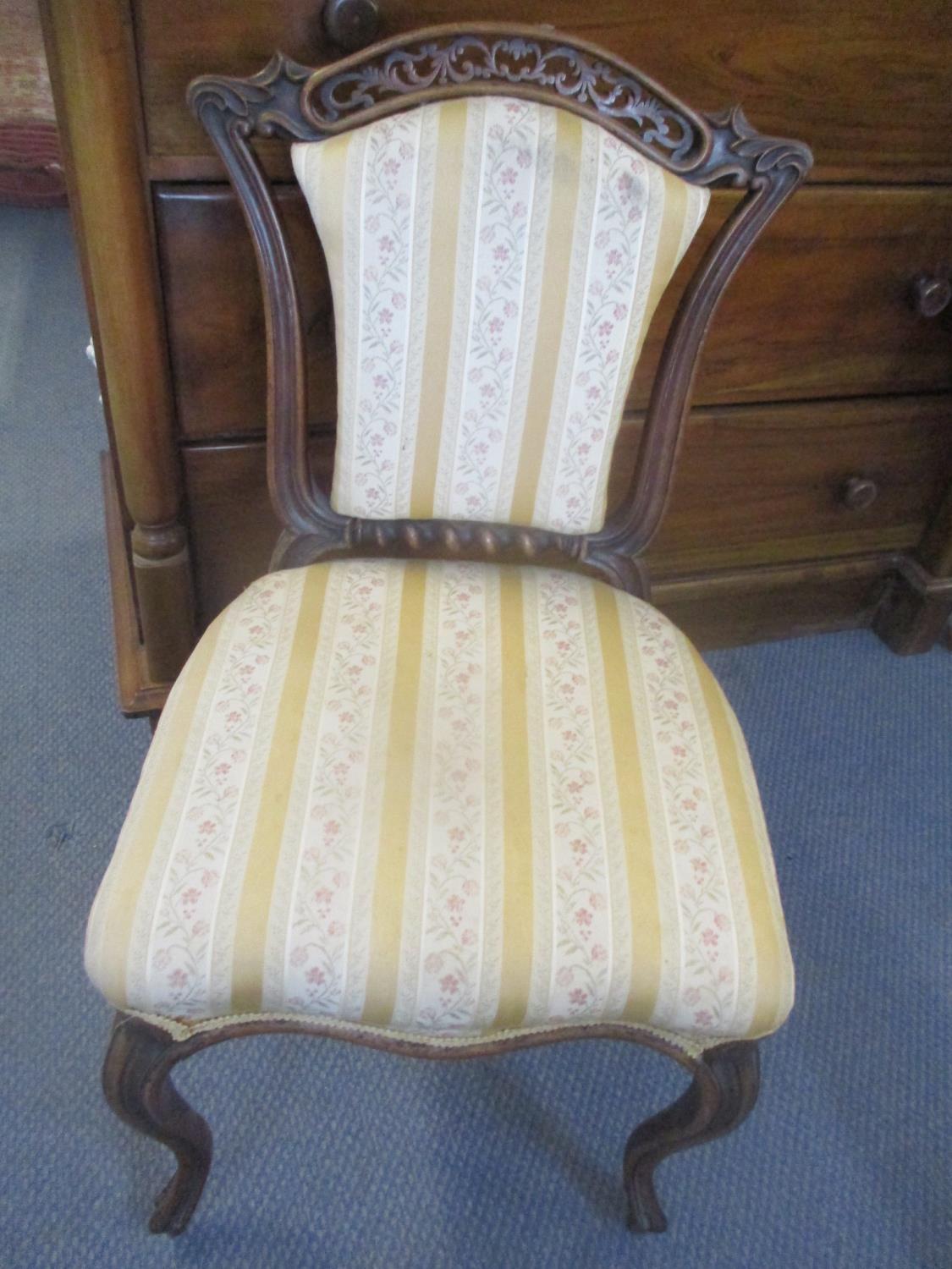 A late 19th century walnut child's chair having pierced fretwork and cabriole front legs