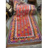 A Kelim rug with geometric motifs in vibrant colours 270cm x 144cm