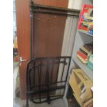 An early 20th century cast iron black painted bed frame